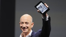Chief Executive Officer Jeff Bezos holds up a Kindle Paperwhite