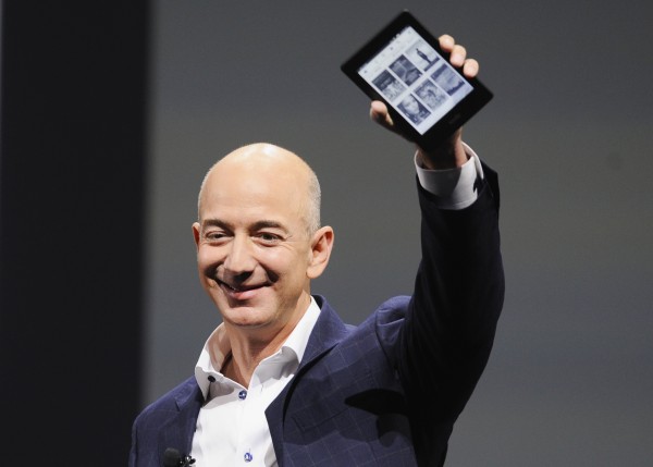 Chief Executive Officer Jeff Bezos holds up a Kindle Paperwhite