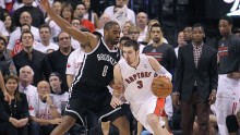 Toronto Raptors point guard Nando de Colo drives past Brooklyn Nets' Alan Anderson