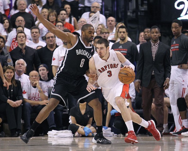 Toronto Raptors point guard Nando de Colo drives past Brooklyn Nets' Alan Anderson