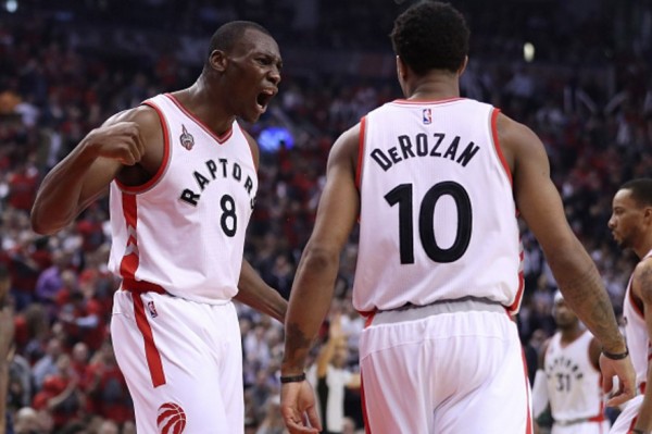 Toronto Raptors center Bismack Biyombo (L) celebrates with teammate DeMar DeRozan