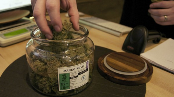 Co-owner Troy Moore measures marijuana at the "Oregon's Finest" medical marijuana dispensary in Portland, Oregon April 8, 2014. (Reuters)