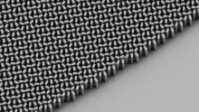 Scanning electron microscope micrograph of the fabricated meta-lens. The lens consists of titanium dioxide nanofins on a glass substrate. Scale bar: 2 mm 
