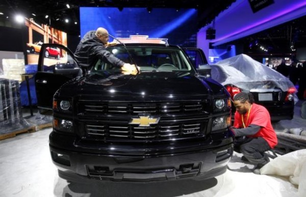 Workers detail a Chevrolet Silverado pickup truck before press days of the North American International Auto Show.