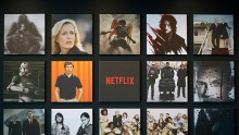 Promotional images of Netflix Inc. programs are displayed on a wall 