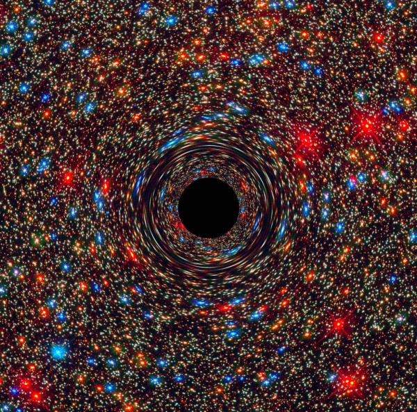 This computer-simulated image shows a supermassive black hole at the core of a galaxy. The black region in the center represents the black hole’s event horizon, where no light can escape the massive object’s gravitational grip. The black hole’s powerful g
