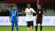 Hebei China Fortune midfielder Stéphane Mbia (middle) reacts with Jiansu Suning's Alex Teixeira during a match