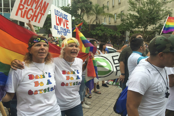 Same-sex couples rallying for equal rights to marry.