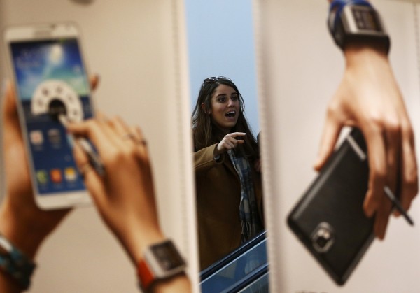 A woman looks at advertisements promoting Samsung Electronics' Galaxy Note 3 smartphone at the company's headquarters in Seoul April 7, 2014. 