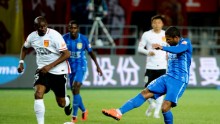 Hebei China Fortune midfielder Stéphane M'Bia (L) runs to the ball as Jiangsu Suning's Jorge Sammir shoots it