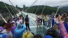 Chinese people trying to break the pane of the world's longest and highest glass bridge.