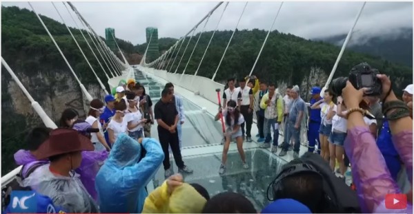 Chinese people trying to break the pane of the world's longest and highest glass bridge.