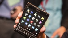 BlackBerry Chief Executive John Chen holds up the unreleased Blackberry Passport device during the company's annual general meeting for shareholders in Waterloo June 19, 2014.