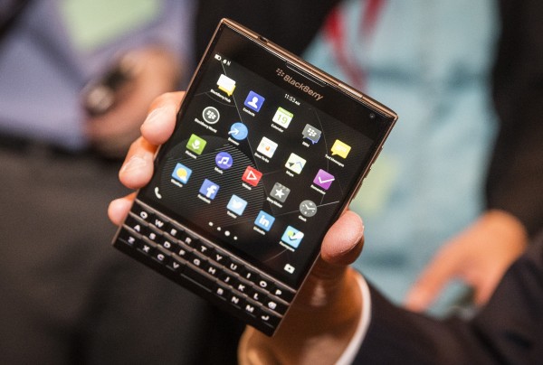 BlackBerry Chief Executive John Chen holds up the unreleased Blackberry Passport device during the company's annual general meeting for shareholders in Waterloo June 19, 2014.