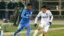 Guangzhou R&F winger Renatinho (L) competes for the ball against Tianjin Teda's Hu Rentian