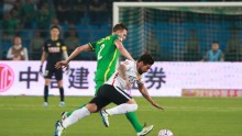 Beijing Guoan defender Egor Krimets (L) competes for the ball against Hebei China Fortune's Ezequiel Lavezzi during their first meeting this season