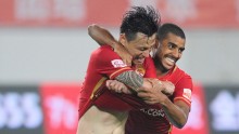 Guangzhou Evergrande forwards Gao Lin (L) and Alan Carvalho