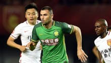 Beijing Guoan striker Burak Yilmaz (middle) against two Hebei China Fortune defenders