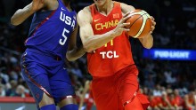 Chinese forward Yi Jianlian drives against Team USA's Kevin Durant.
