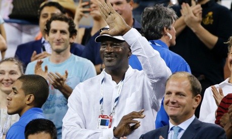 Michael Jordan waves to Roger Federer from the stands