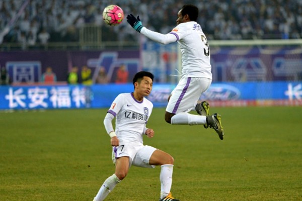 Tianjin Teda players Li Benjian (L) and Zainadine Junior