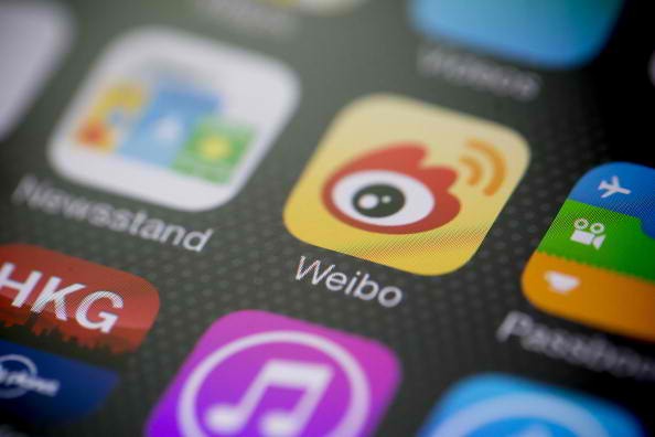 Weibo microblogging service app icon is displayed on an Apple Inc. iPhone 5s in an arranged photograph in Hong Kong, China.