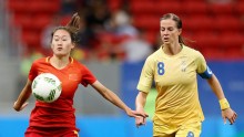 China defender Wu Haiyan competes for the ball against Sweden's Schelin Lotta