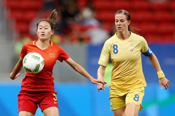 China defender Wu Haiyan competes for the ball against Sweden's Schelin Lotta