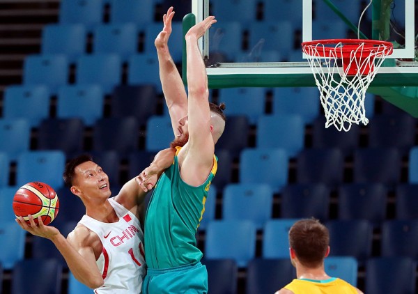 Chinese star Yi Jianlian tries to score against Australia's Aron Baynes