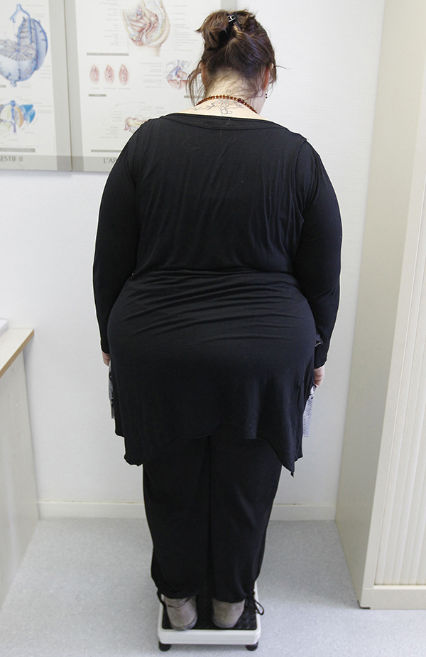 Obese woman weighing