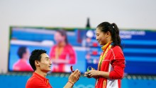  Chinese diver Qin Kai proposes to silver medalist He Zi of China on the podium during the medal ceremony for the Women's Diving 3m Springboard Final on Day 9 of the Rio 2016 Olympic Games at Maria Lenk Aquatics Centre on August 14, 2016 in Rio de Janeiro