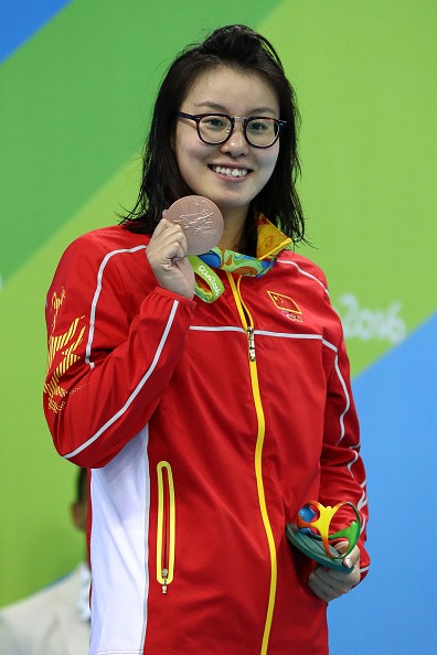 Bronze medalist Yuanhui Fu of China on the podium during the medal ceremony for the Women's 100m Backstroke Final on Day 3 of the Rio 2016 Olympic Games at the Olympic Aquatics Stadium on August 8, 2016 in Rio de Janeiro, Brazil. 