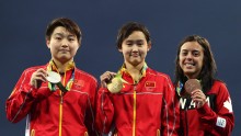 Silver medalist Yajie Si of China, gold medalist Qian Ren of China and bronze medalist Meaghan Benfeito of Canada pose on the podium during the medal ceremony for the Women's 10m Platform final diving contest at the Maria Lenk Aquatics Centre on day 13 of