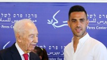 Former Israel President Shimon Peres (L) appoints Guangzhou R&F forward Eran Zahavi as Ambassador of Peace in Sport