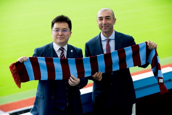 Aston Villa's Dr. Tony Xia (L) and Roberto Di Matteo