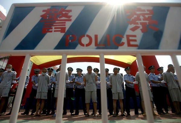 Police parade convicted criminals during a public sentence August 1, 2006 in Shenzhen of Guangdong Province, China. 