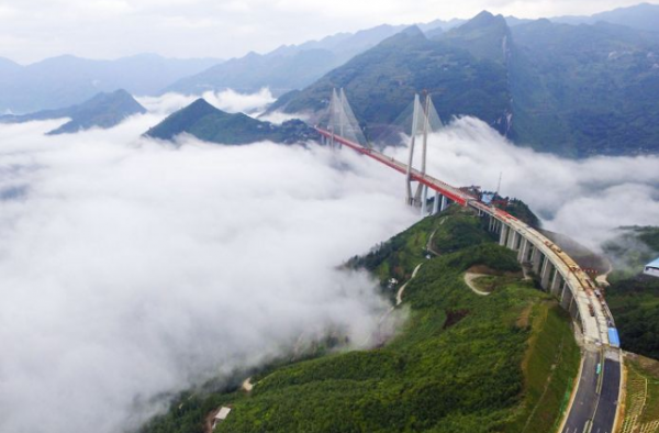 Beipanjiang Bridge spans 2,362 feet between mountains and 1,854 feet above the river below.