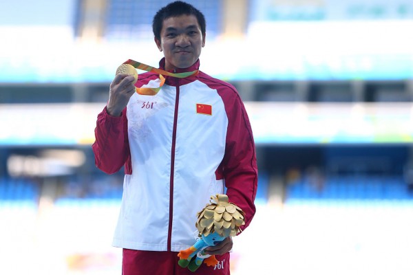 Gold medalist Jianwen Hu of China poses on the podium at the medal ceremony