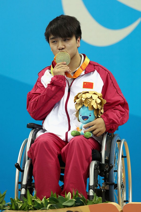 Gold medalist Wenpan Huang of China celebrates on the podium at the medal ceremony for the Mens 50m Freestyle S3