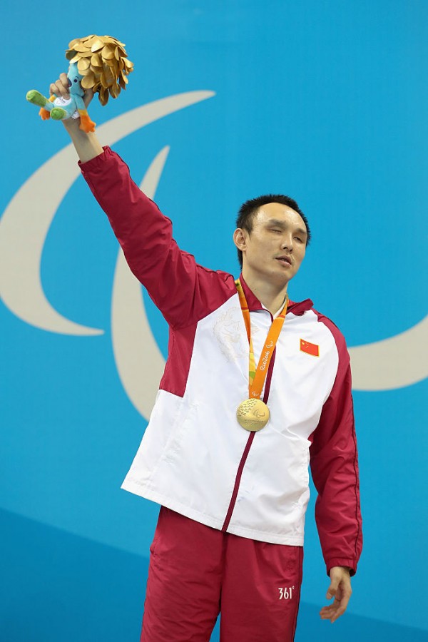 Gold medalist Bozun Yang of China celebrates on the podium at the medal ceremony for the Mens 100m Breaststroke SB11 Final