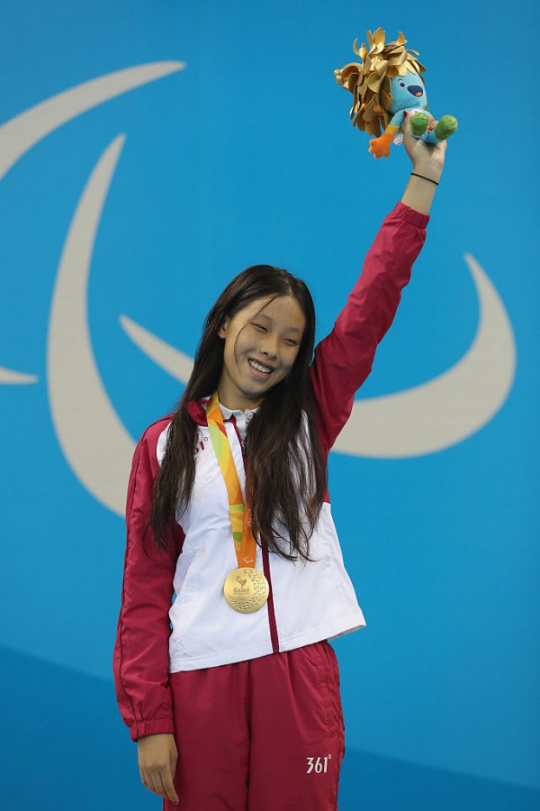 Gold medalist Xiaotong Zhang of China celebrates on the podium at the medal ceremony for the Womens 100m Breaststroke SB11 Final 