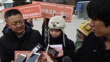 Qiu Bai, speaks to the media with her lawyer Wang Zhenyu (L) before entering the Beijing No.1 Intermediate People's Court in Beijing on November 24, 2015. Qiu Bai took the government to court over textbooks describing homosexuality as a 'psychological dis