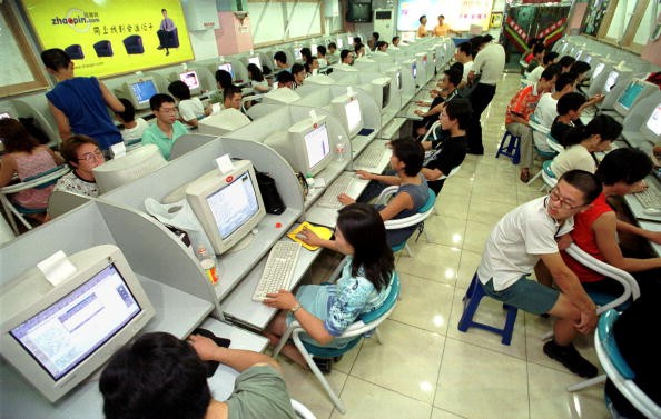 Young people surf the web August 17, 2000 near Peking University, China. 