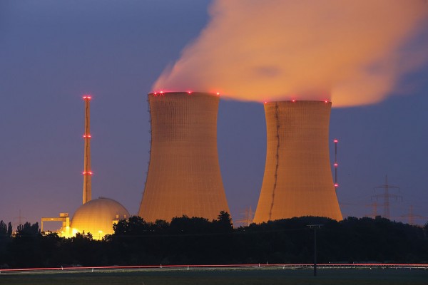 Passing cars leave a streak of light as steam rises from the cooling towers of the Grafenrheinfeld nuclear power plant at night on June 11, 2015 near Grafenrheinfeld, Germany. 