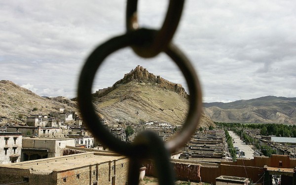 The former local government palace is framed by an iron ring in Gyantse township of Tibet, China.