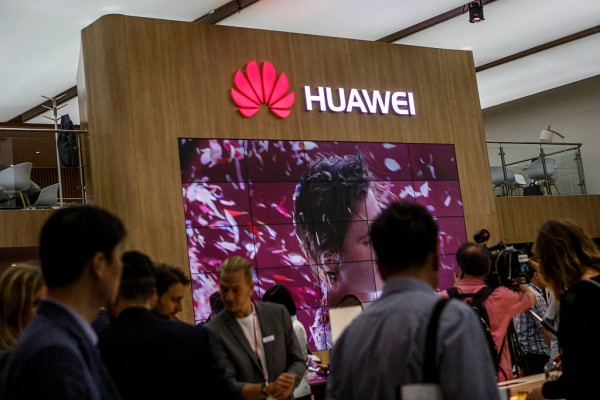  Visitors passing the stand of Huawei at the 2016 IFA consumer electronics trade fair on September 2, 2016 in Berlin, Germany.