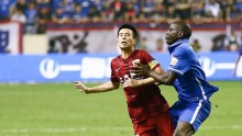 Shanghai Shenhua striker Demba Ba (R) clashes with Shanghai SIPG's Sun Xiang
