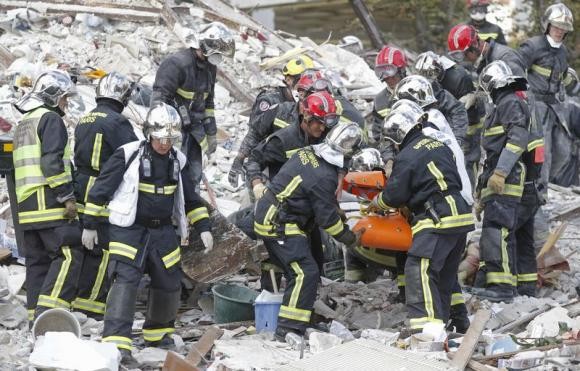 Rescuers at Rosny-sous-Bois carry bodies of victims after explosion