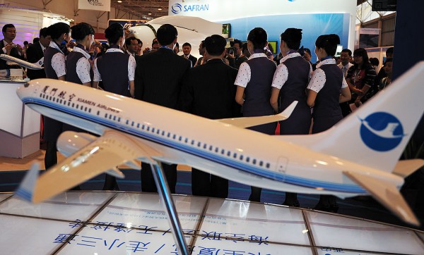 Visitors pose for pictures with stewardess of Xiamen Airlines at the 7th China International Aviation and Aerospace Exhibition on November 4, 2008 in Zhuhai of Guangdong Province, China.