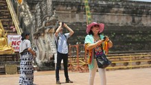  Chinese tourists take pictures at Wat Chedi Luang on April 17, 2014 in Chiang Mai, Thailand.